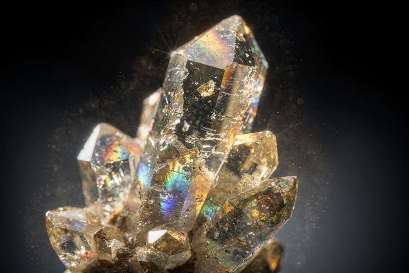 Polished zircon crystal displaying its brilliant sparkle and deep golden-brown coloring.