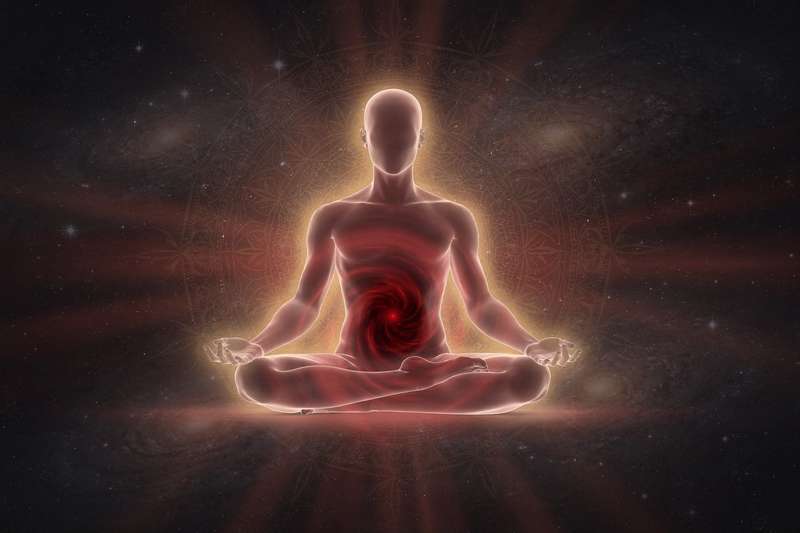 Grounded yoga practitioner in red clothing performing a standing forward fold to strengthen root chakra stability.