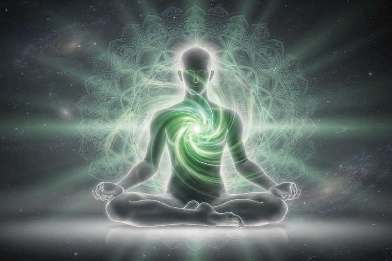 Green and pink crystals arranged in a heart shape symbolizing love, compassion, and emotional healing energy.