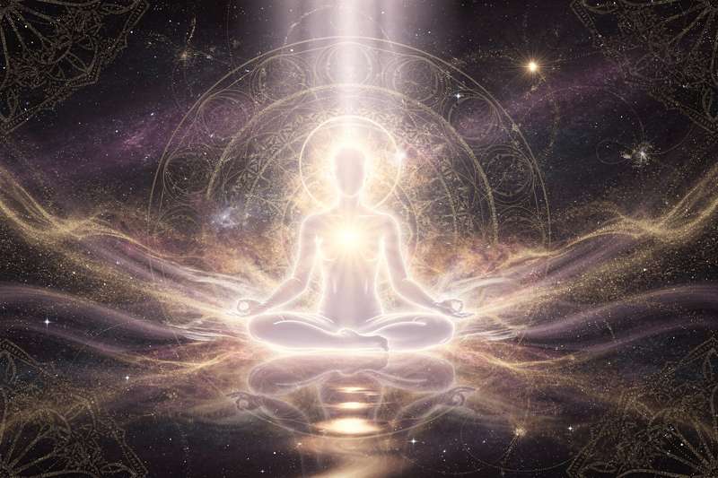 Meditating person surrounded by glowing light symbolizing spiritual awakening and consciousness expansion.
