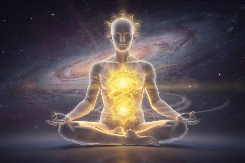 Yellow and golden crystals arranged in a circle around a glowing solar plexus chakra symbol on the body.