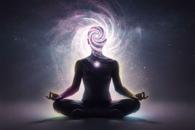 Purple and white foods like grapes, blueberries, and coconut arranged on a plate to support crown chakra healing.