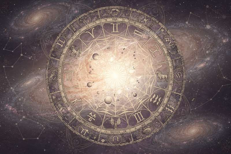 Person reading astrology chart while contemplating their birth sign characteristics and personality traits.