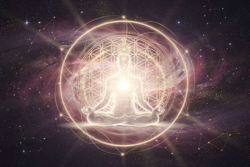 Peaceful meditation space with candles and crystals arranged for manifestation practice.