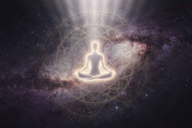 Person meditating peacefully in nature, symbolizing the spiritual journey of releasing attachment and finding inner peace.
