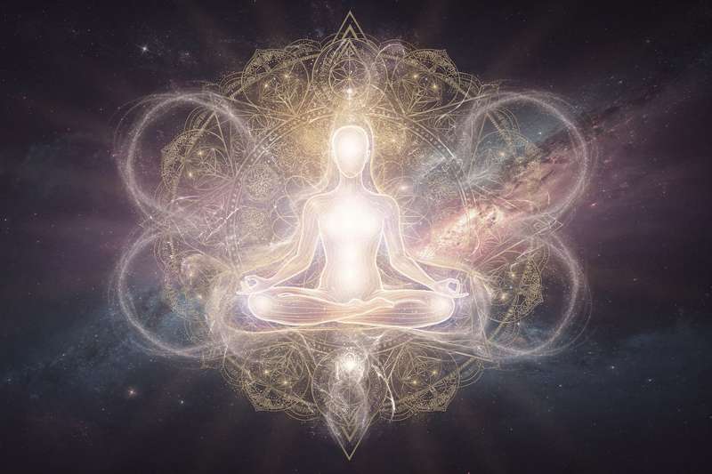 Person meditating peacefully in nature, releasing tension and embracing acceptance of life's uncertainties.